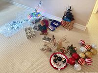 overall view of assorted Christmas decorations, lights lit, wrapping supplies, ornaments
