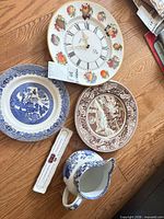 Front view of all five ceramic items on floor