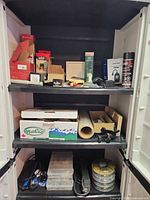Full view of cabinet shelves with assorted hardware items