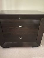 Front view of nightstand showing two drawers and silver pulls
