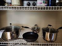 All pots, pans and lids on shelf