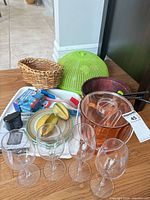 Overview showing tray, wine glasses, ice bucket, dome, basket, plates and utensils