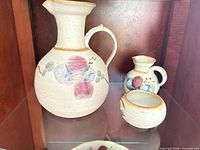 Large pitcher alongside smaller pieces showing overall style and condition