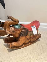 Right side view of carved wood elephant rocker
