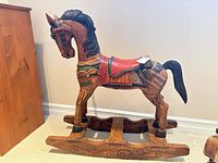 Left side view of whole rocking horse showing carving and paint