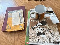 Binder, stack of publications and mug