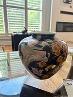 Profile view of cobalt blue porcelain vase with bird and floral design