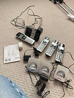 Overview of base station, three handsets, three cradles, power adapter and manual