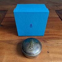 Sterling silver box in front of Birks blue presentation box