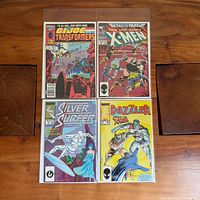 All four comics bagged with boards