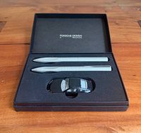 Boxed set showing pen, pencil, toy car, Porsche Design branding