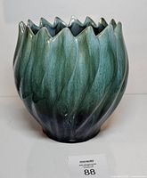 Front view showing green-to-black glaze and fluted rim