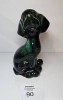 Front view of green drip glaze ceramic dog figurine