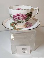 Teacup on saucer front view showing floral motif