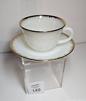 Teacup on saucer showing profile and gold rim