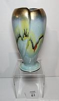 Front view of tall drip glaze vase on stand