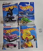 Front view of all four Hot Wheels cars on cards