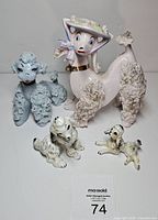 Group shot showing all four poodle figurines