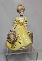 Front view showing full figure, dress, hat, basket