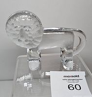 Full side view of clear glass Kosta Boda lion