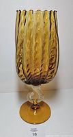 Full view of amber ribbed vase, clear spiral stem, amber foot