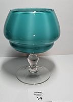 Front view showing teal cased glass bowl on clear stem and foot