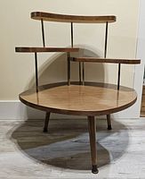 full view of three-tier formica table against wall