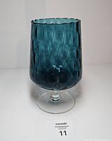 Full view of teal optic Empoli vase on white background