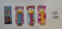 Full lot showing three PEZ dispensers and candy refill pack