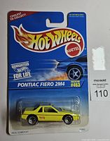 Front of sealed Hot Wheels card showing Pontiac Fiero 2M4