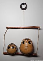Full view of hanging gourd owl decor on wall
