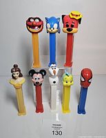 Front view showing all eight character PEZ dispensers standing upright