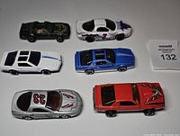 Six die-cast Pontiac Firebird cars arranged in two rows