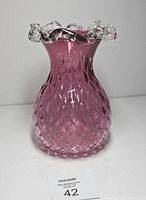 Front view of cranberry glass vase showing diamond optic pattern and ruffled clear rim