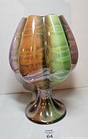 Front view showing multicolor luster glaze and pedestal base