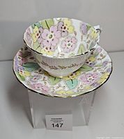 Teacup nested on saucer top view showing full floral pattern