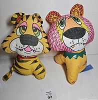 Front view of tiger and lion plush toys