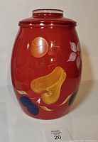 Front view of red cookie jar with lid