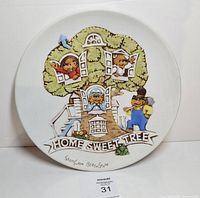 Front of plate showing raised, painted design and title