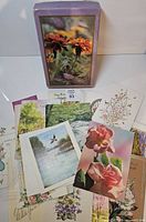 assorted greeting cards spread with purple photo box