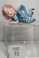 Front view of ceramic bloomer girl figurine on clear stand