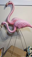 Both flamingo ornaments standing together showing size and form