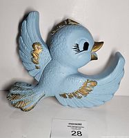 Front view of light blue chalkware bluebird with gold accents