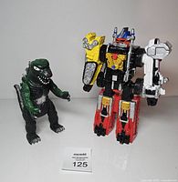 Front view of Godzilla and Megazord figures standing side by side