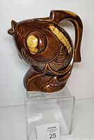 Front view showing fish shape, glaze, handle