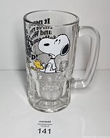 Front view of clear glass stein showing Snoopy and Woodstock graphic