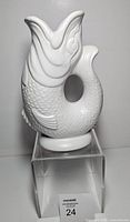 Front view of white fish pitcher on clear stand