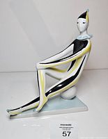 Front angled view of porcelain clown showing colors and seated posture