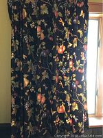 Three-piece fruit-themed curtains and valence with dark background and fruit, hung in window