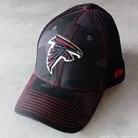 Oblique view showing overall hat, camo front, mesh side, logo, visor